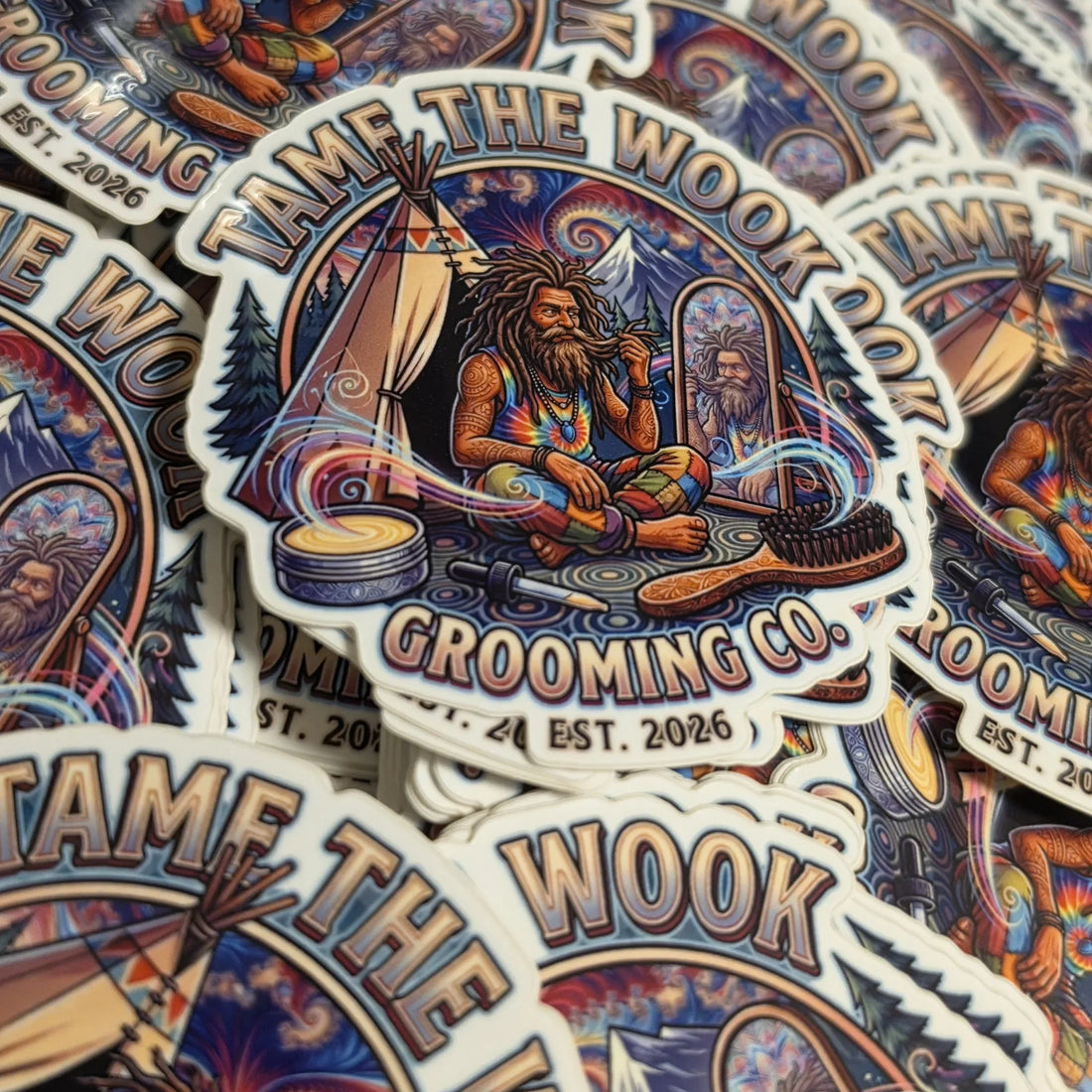 A heap of Tame the Wook Grooming Co. emblem stickers